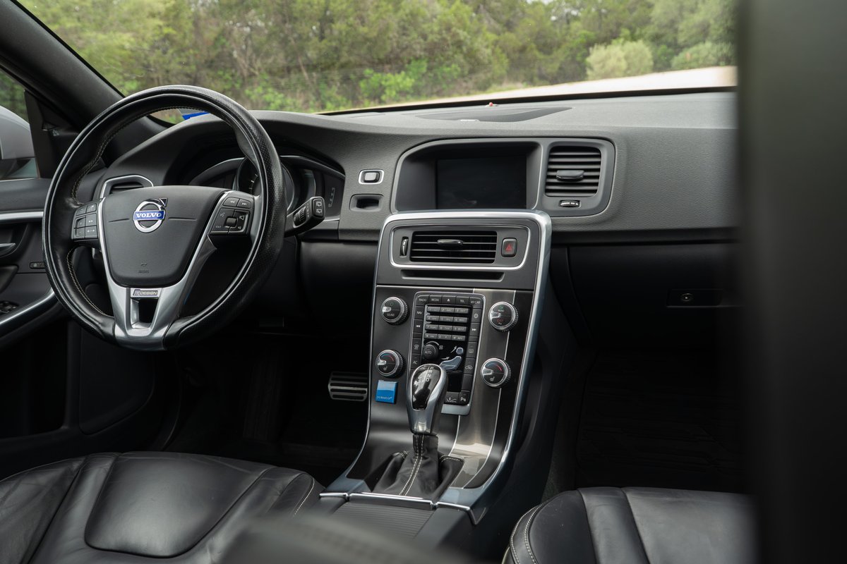 Interior of a 2015 Volvo V60 R-Design Polestar, black leather seats, silver trim.