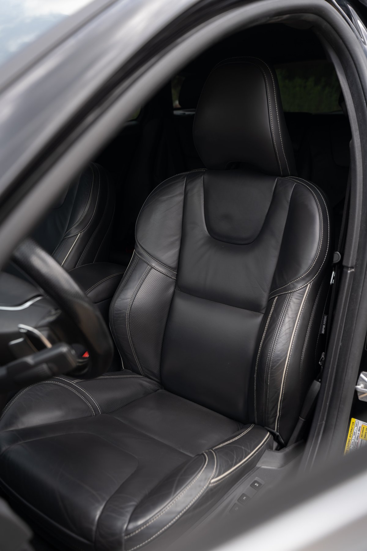 Black leather sport seats with contrast stitching in a 2015 Volvo V60 R-Design Polestar.