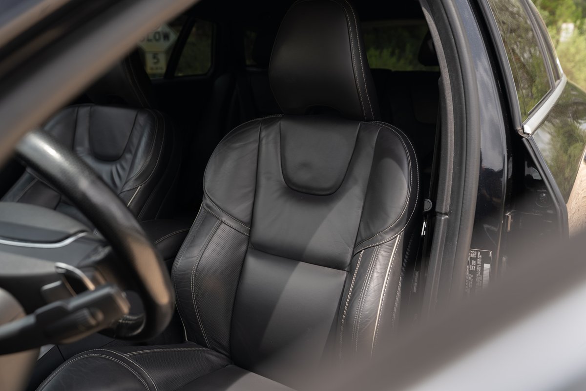 Black 2015 Volvo V60 R-Design Polestar interior. Leather sport seats, steering wheel.