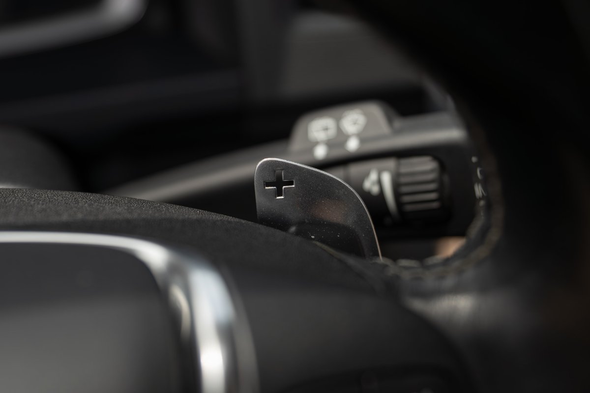 Close-up of metal paddle shifters on a 2015 Volvo V60 R-Design Polestar steering wheel.