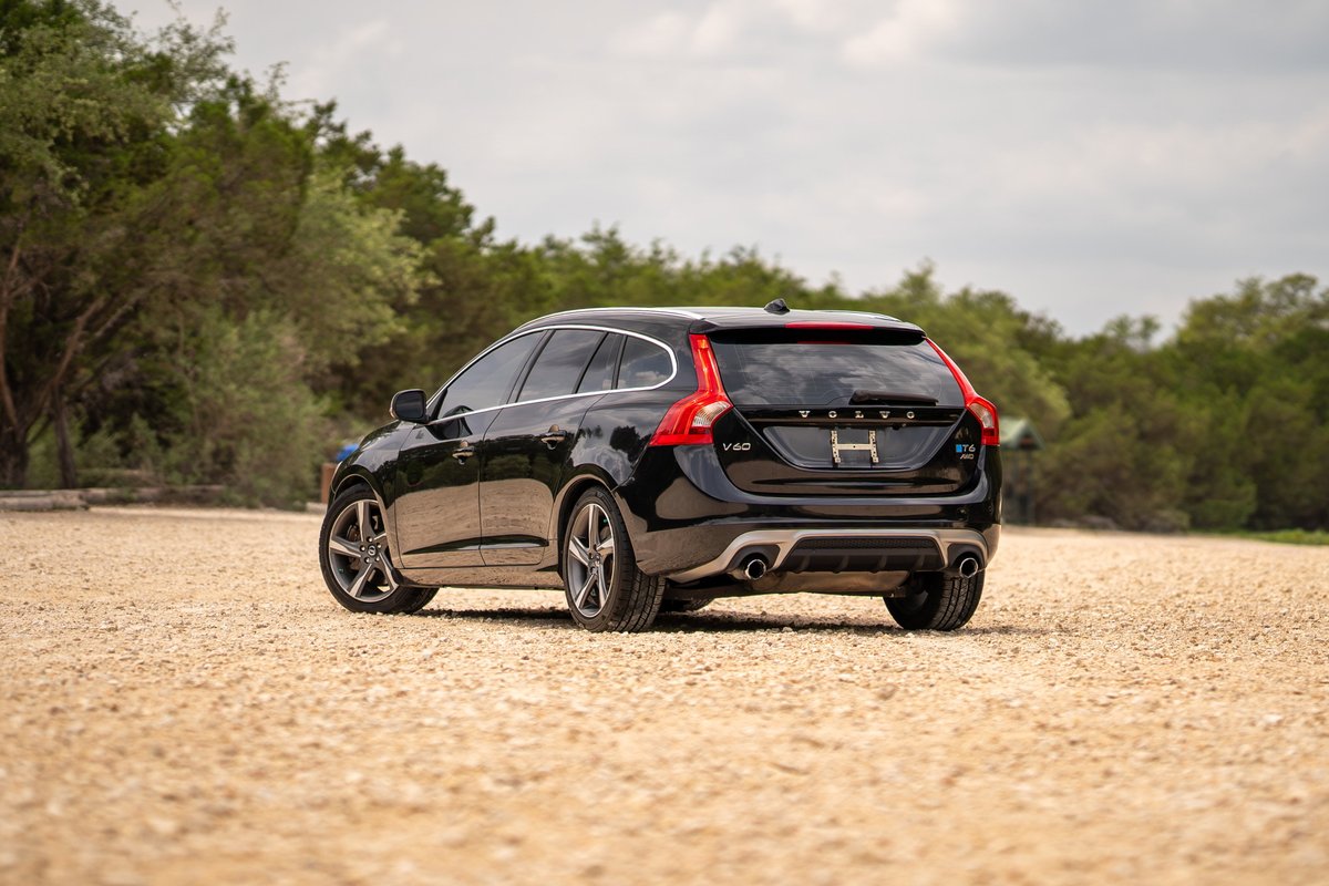 Black 2015 Volvo V60 R-Design Polestar with silver rims and dual exhaust.