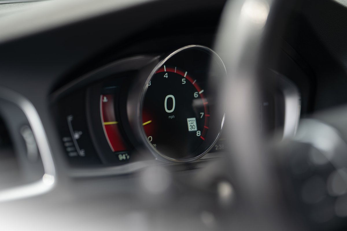 2015 Volvo V60 R-Design Polestar digital instrument cluster showing 0 mph and speed limit sign.