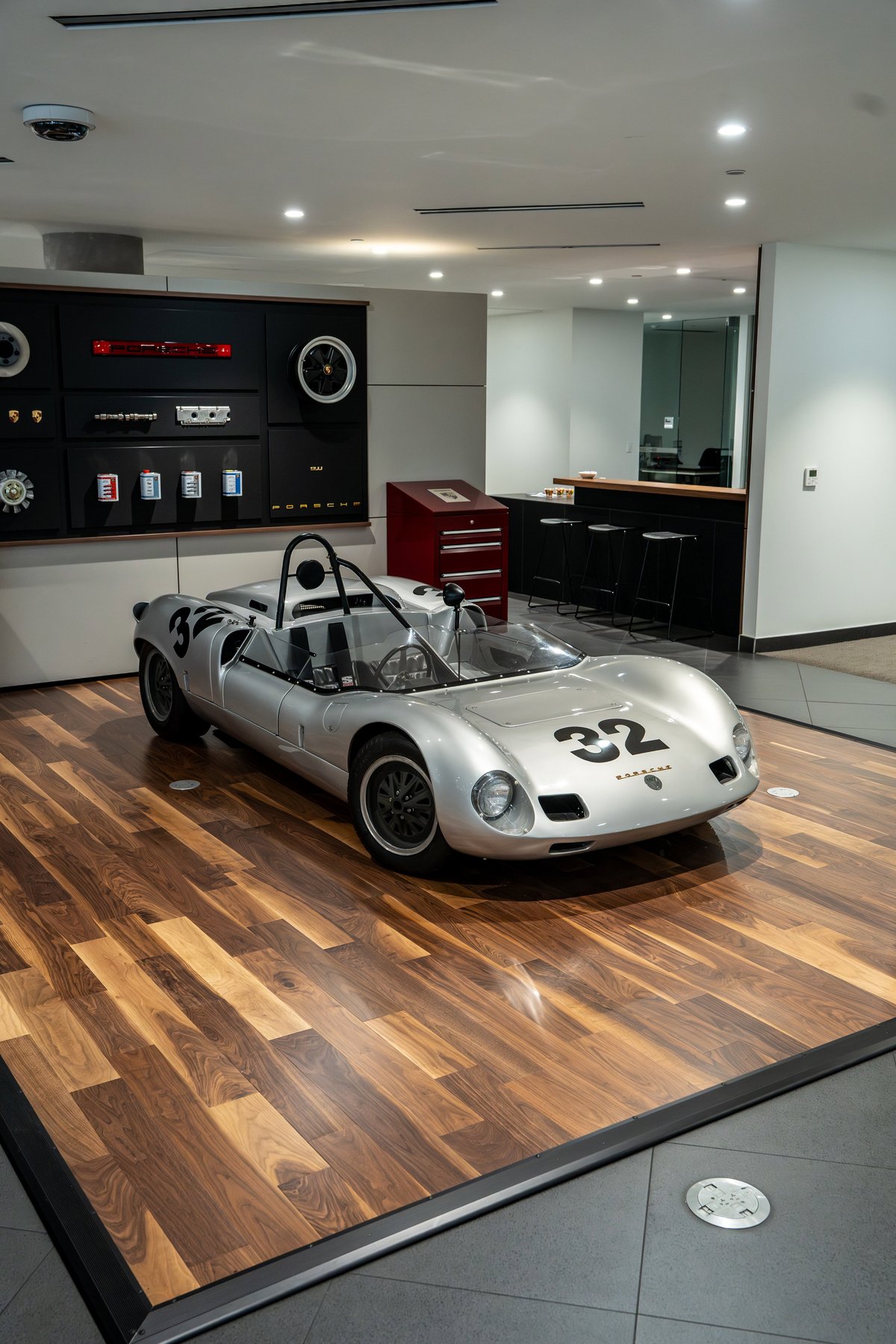 1964 Elva Porsche 4-Cam silver race car with black rims and racing livery.