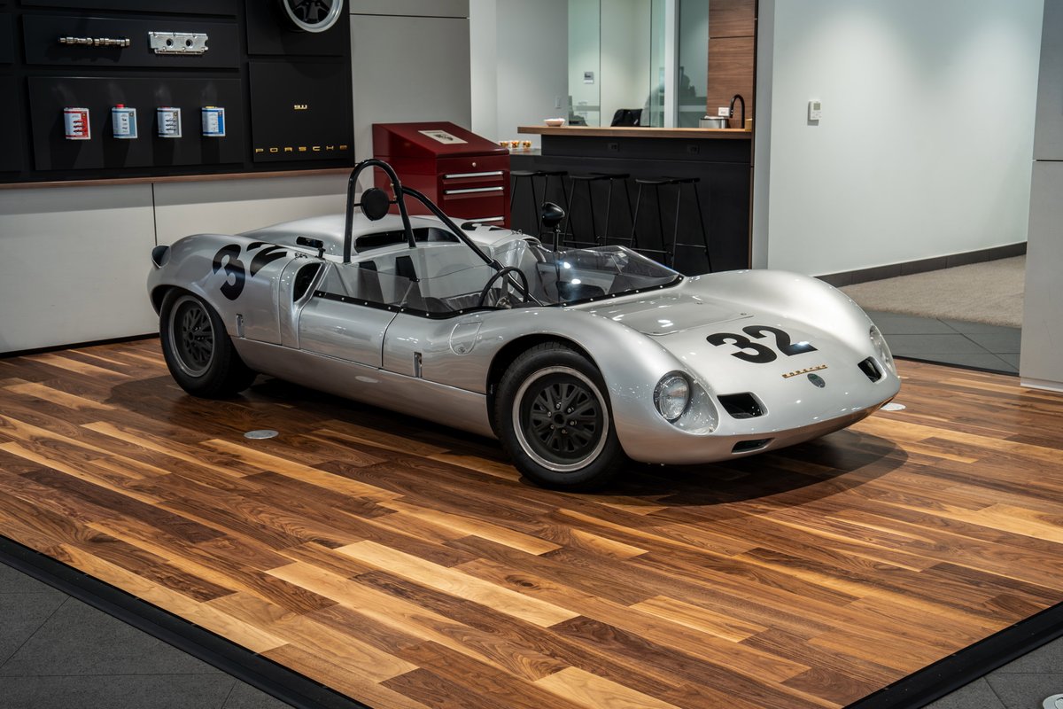 1964 Elva Porsche 4-Cam silver race car with black number livery and rims.