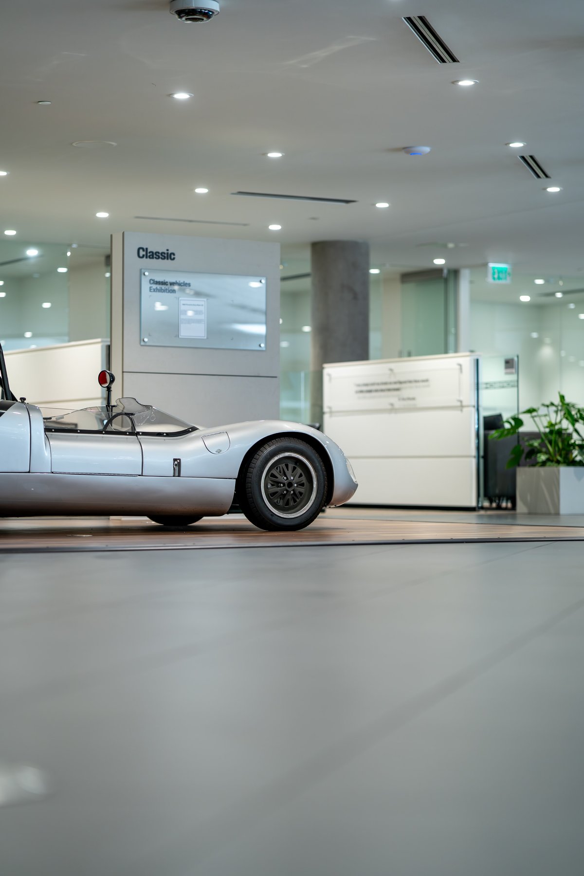 Silver 1964 Elva Porsche 4-Cam. Classic sports car exterior, black wire-spoke rims.