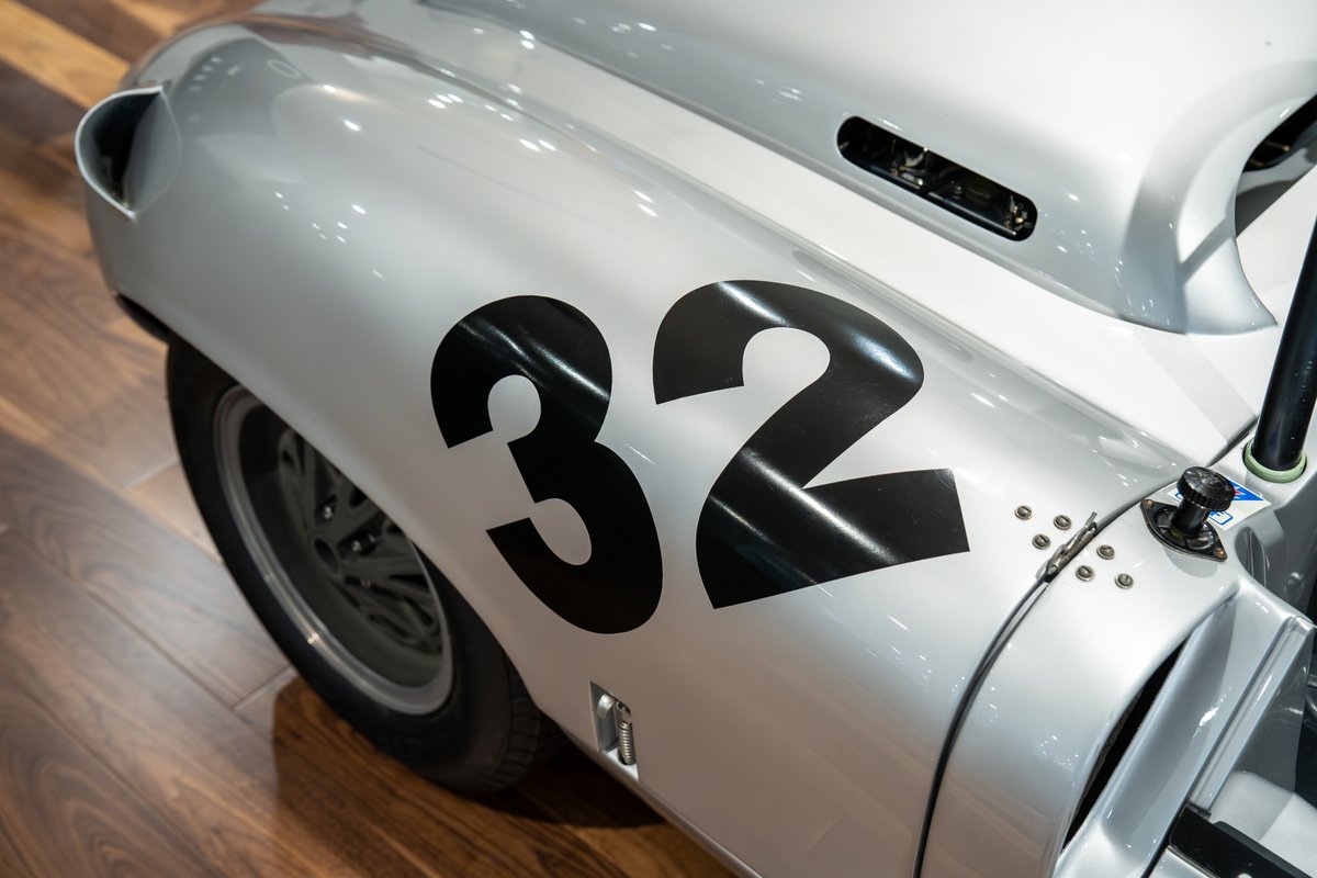 Silver 1964 Elva Porsche 4-Cam race car with black number 32 livery.