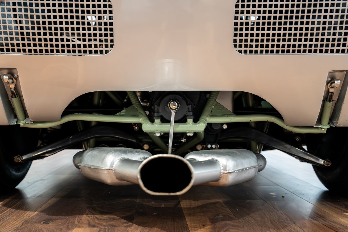 Rear view of a 1964 Elva Porsche 4-Cam with a dual exhaust system and visible suspension components.