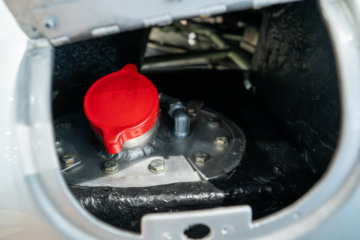 Close-up of the red fuel filler cap on a 1964 Elva Porsche 4-Cam.