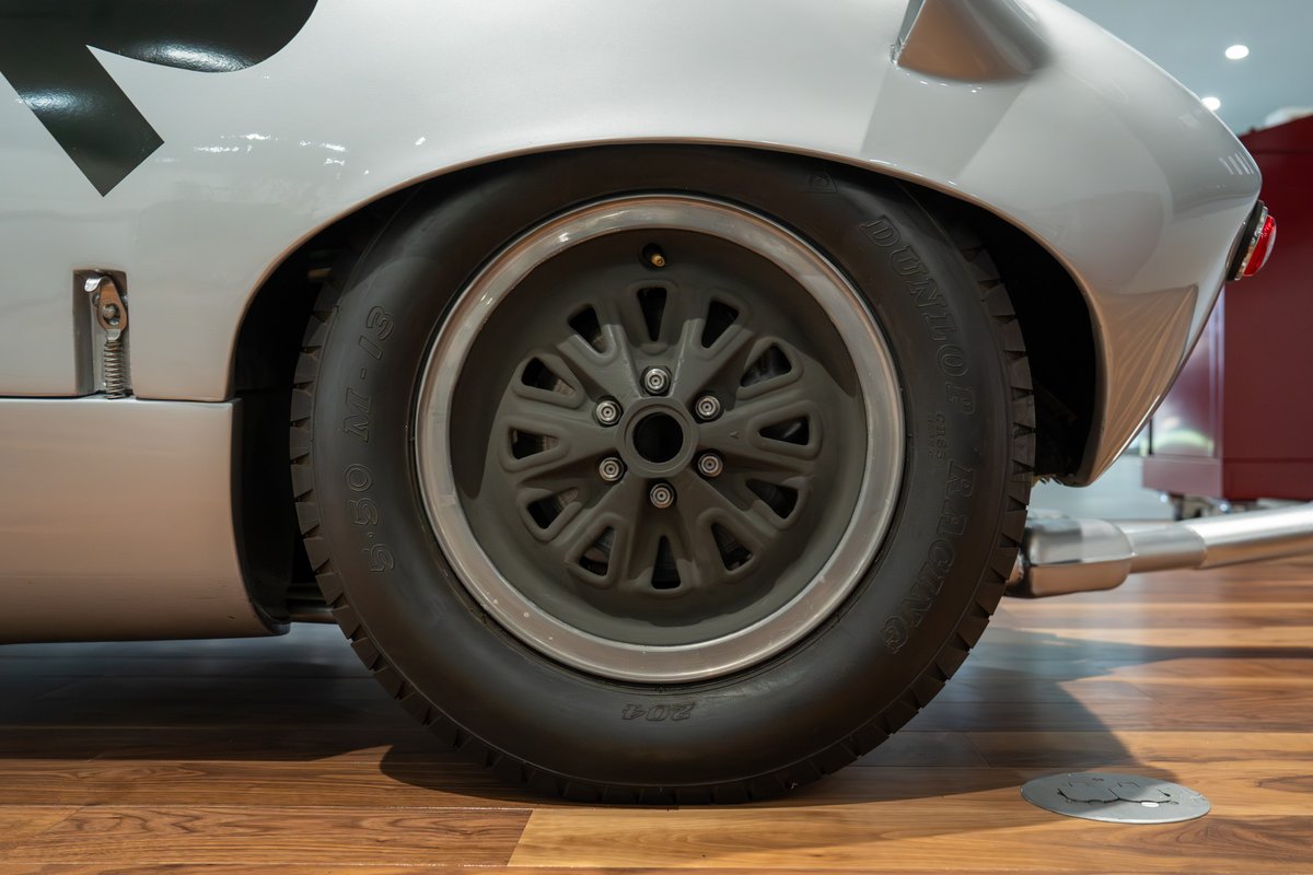 1964 Elva Porsche 4-Cam rear wheel with silver-lipped, multi-spoke racing rims and black tire.