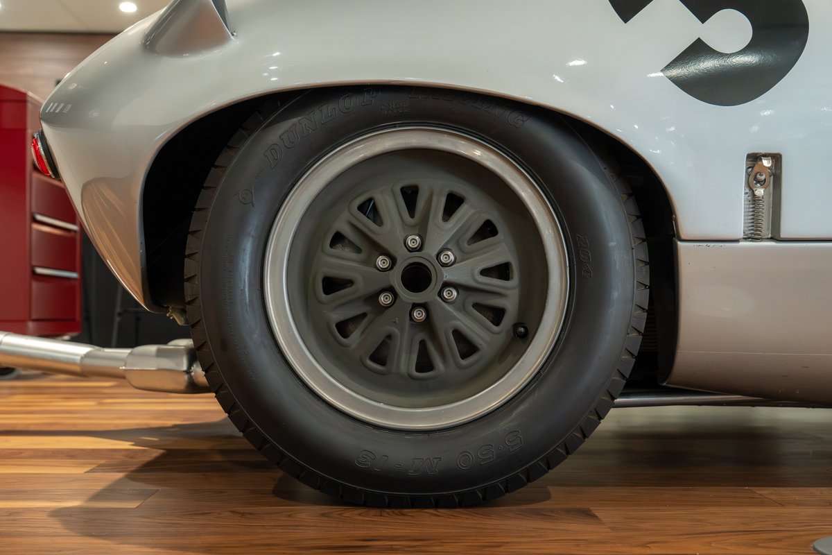 Classic 1964 Elva Porsche 4-Cam race car with grey multi-spoke rims and racing livery.