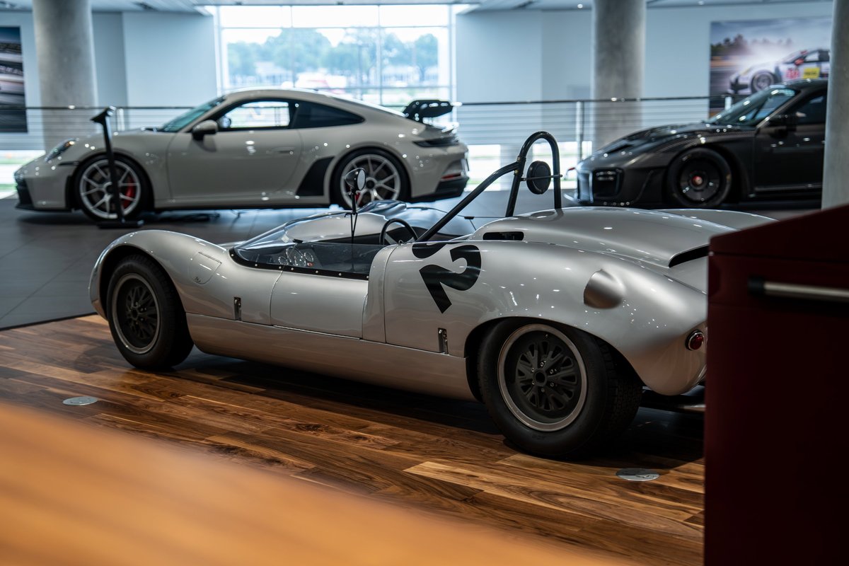 Silver 1964 Elva Porsche 4-Cam race car with black number '2' livery on wire-spoke rims.