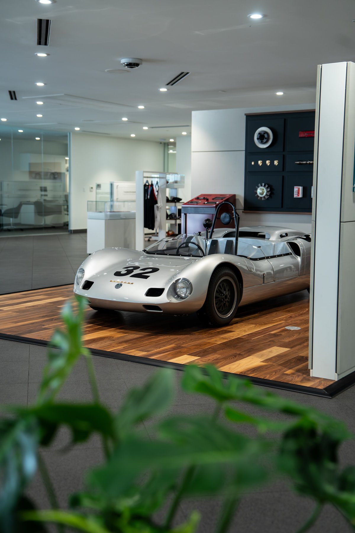 1964 Elva Porsche 4-Cam race car with silver livery and black rims.