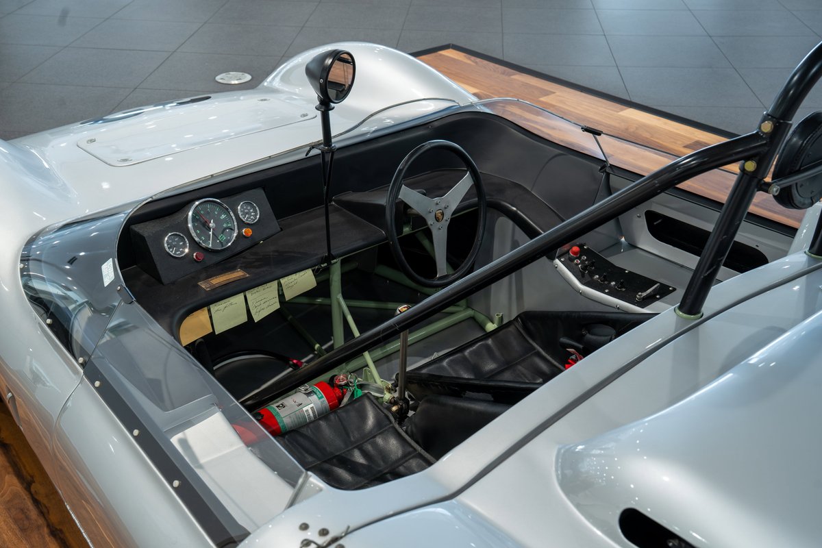1964 Elva Porsche 4-Cam race car cockpit with vintage gauges, roll bar, and racing seat.