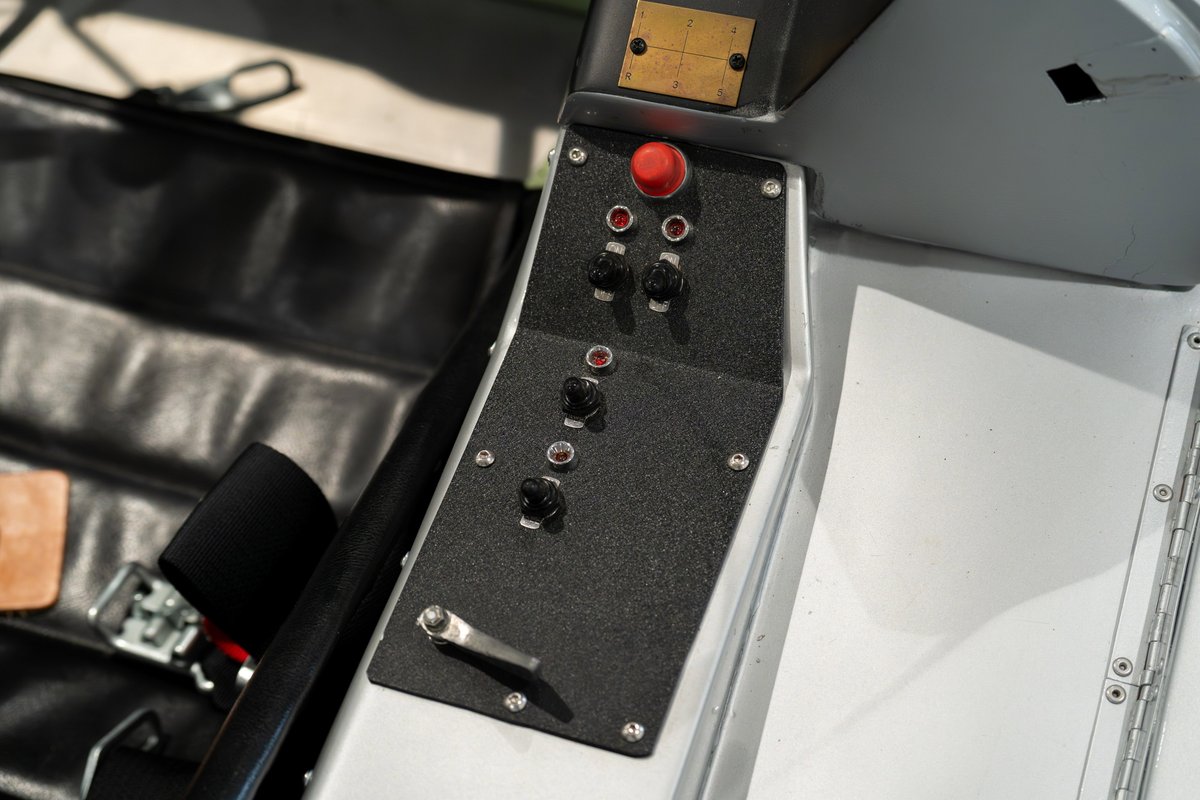 1964 Elva Porsche 4-Cam dashboard with red button and black toggles.