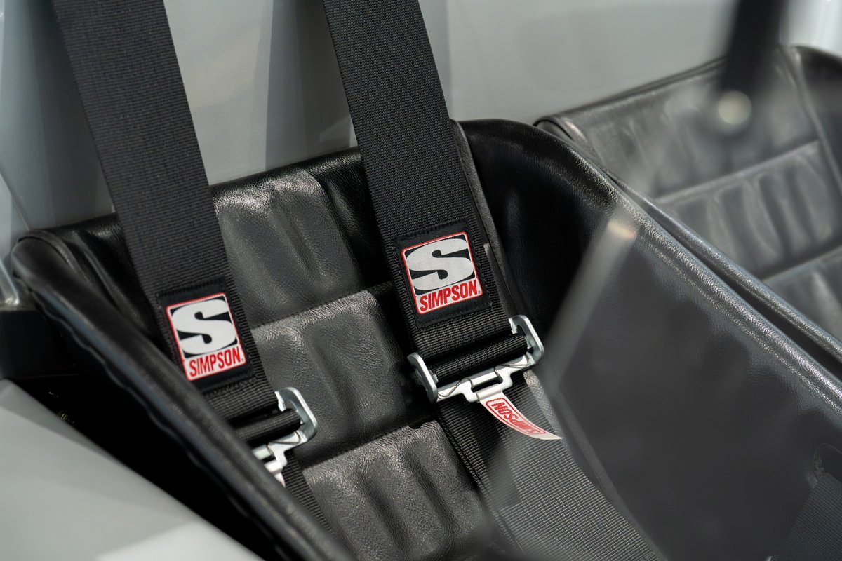 Black Simpson racing harnesses on bucket seats of a 1964 Elva Porsche 4-cam.