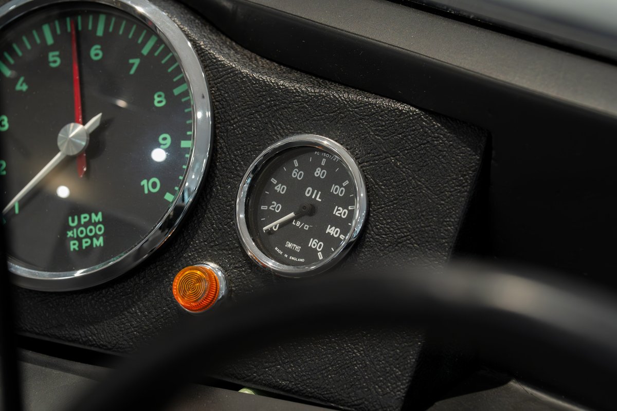 Close-up of the 1964 Elva Porsche 4-Cam dashboard, showing the tachometer & oil pressure gauge.