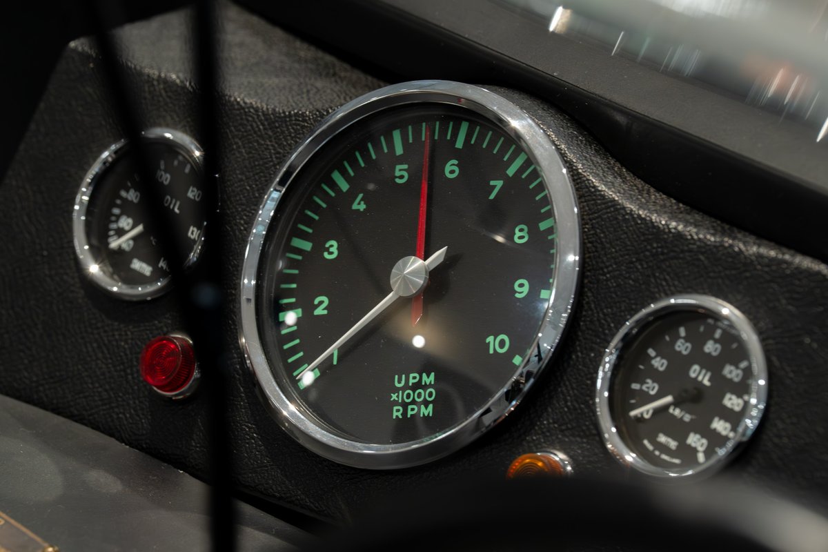 Dashboard of a 1964 Elva Porsche 4-Cam, featuring a tachometer and oil pressure gauge.