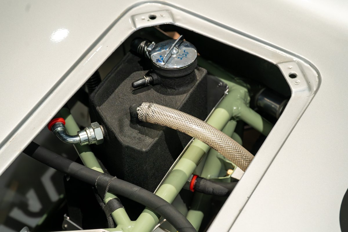Close-up of the 1964 Elva Porsche 4-Cam's engine bay, showing coolant reservoir and plumbing.