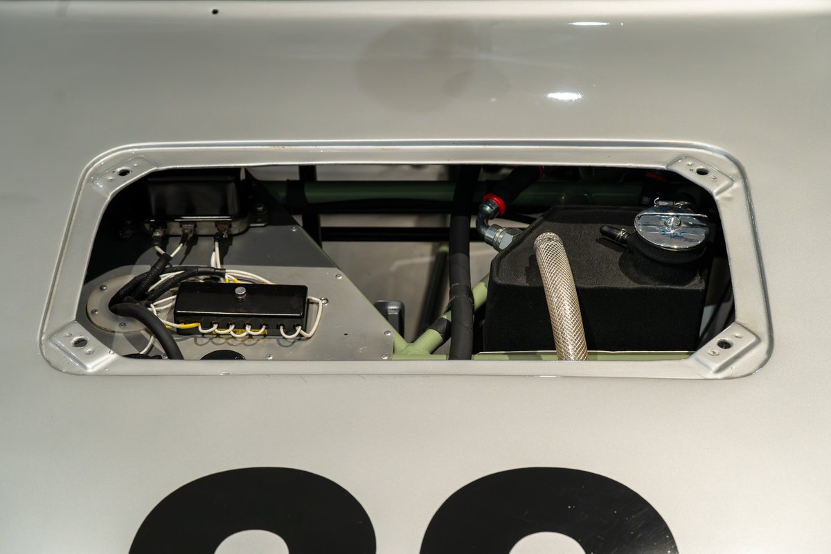 1964 Elva Porsche 4-Cam with a silver finish. Close-up on the engine bay with fuel tank and electrical components.