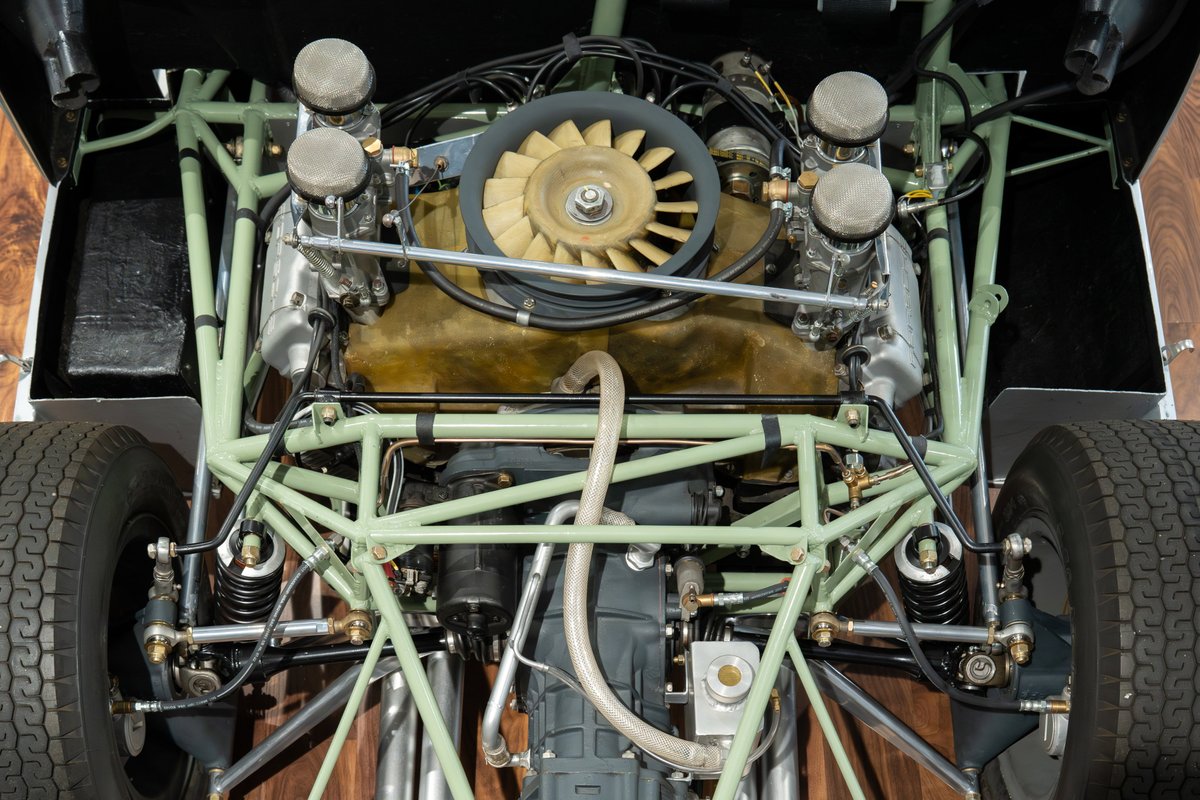 1964 Elva Porsche 4-Cam underside view, showing powertrain, suspension, and rear tires.