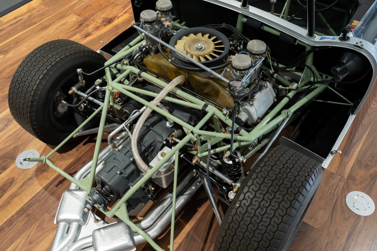 1964 Elva Porsche 4-Cam race car chassis with V8 engine and exposed tubular frame.
