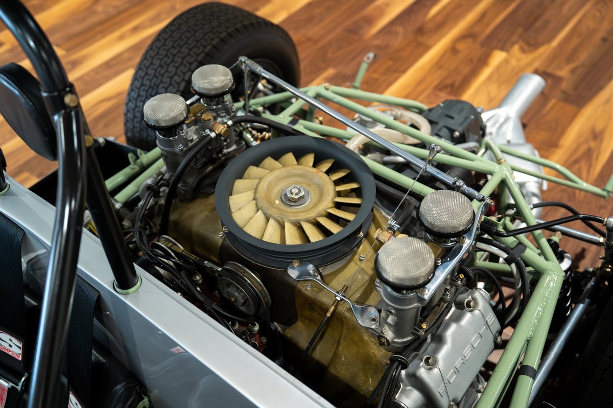 1964 Elva Porsche 4-Cam engine bay with exposed carbs, fan, and green roll cage.