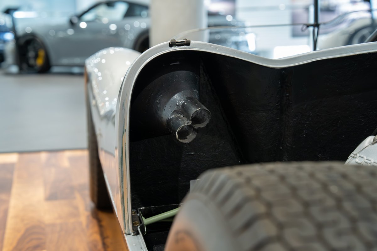 Close-up of a 1964 Elva Porsche 4-Cam's triple exhaust pipes.