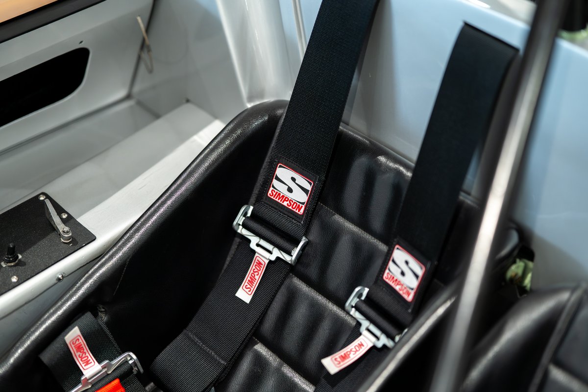 Close-up of black Simpson racing harnesses in a 1964 Elva Porsche 4-Cam cockpit.