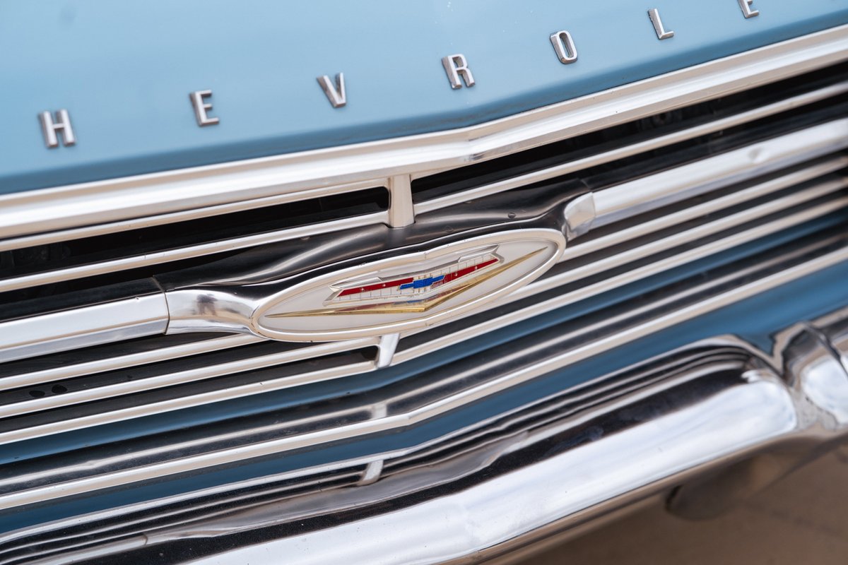 Close up of a blue 1963 Chevrolet Impala low rider grille and emblem.