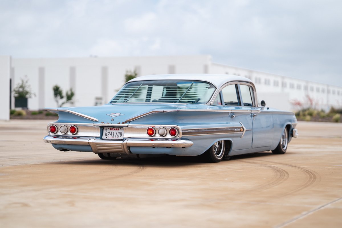 Low-rider 1960 Chevrolet Impala, powder blue, with chrome trim and custom rims.