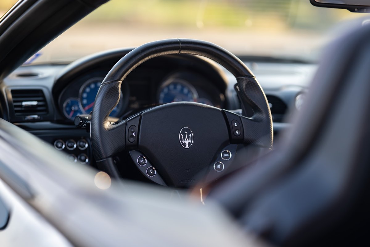 Maserati GranTurismo steering wheel with Trident logo and instrument cluster.