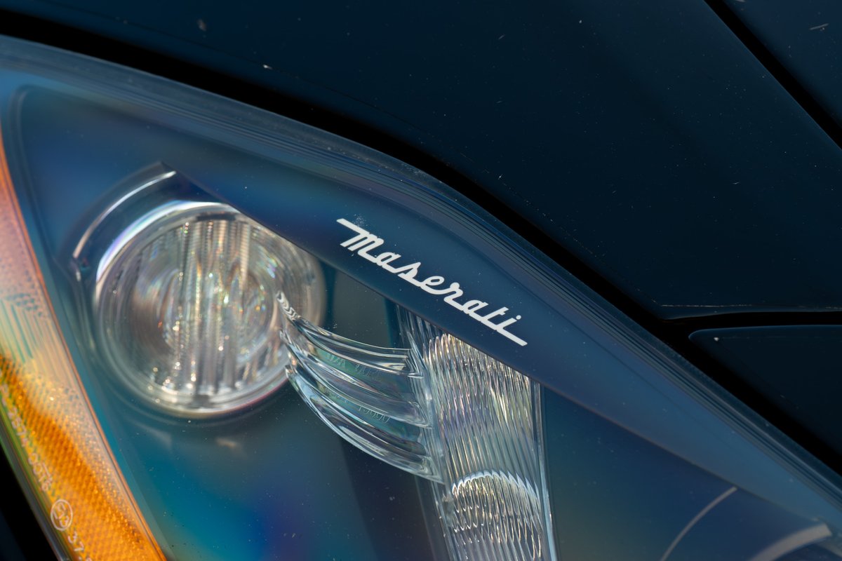 Maserati GranTurismo headlight trim with the Maserati script logo.