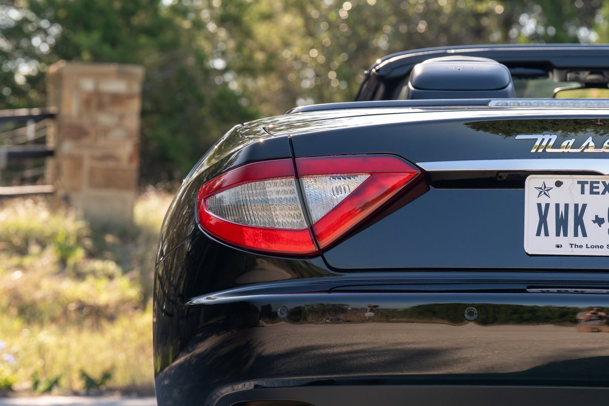 Black 2016 Maserati GranTurismo convertible rear driver side taillight detail.