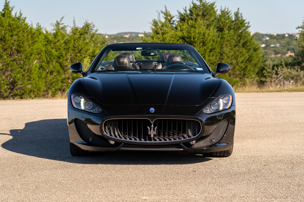 Front view of a black 2016 Maserati GranTurismo convertible with chrome trim and headlights.