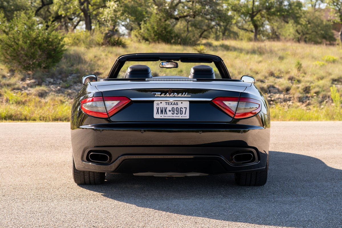 2016 Maserati GranTurismo convertible in black, rear view.