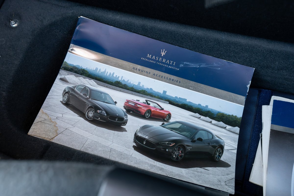Maserati GranTurismo brochure featuring a black coupe and a red convertible.