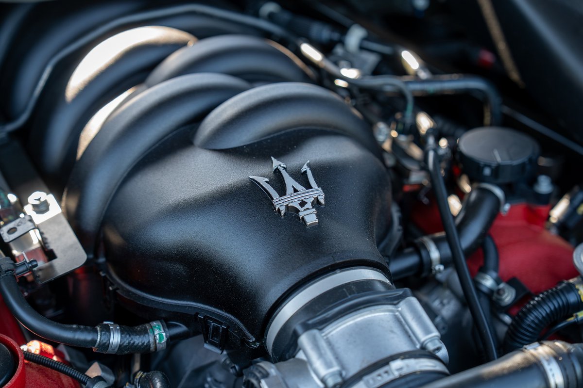 Maserati GranTurismo engine bay with Trident logo on intake manifold.