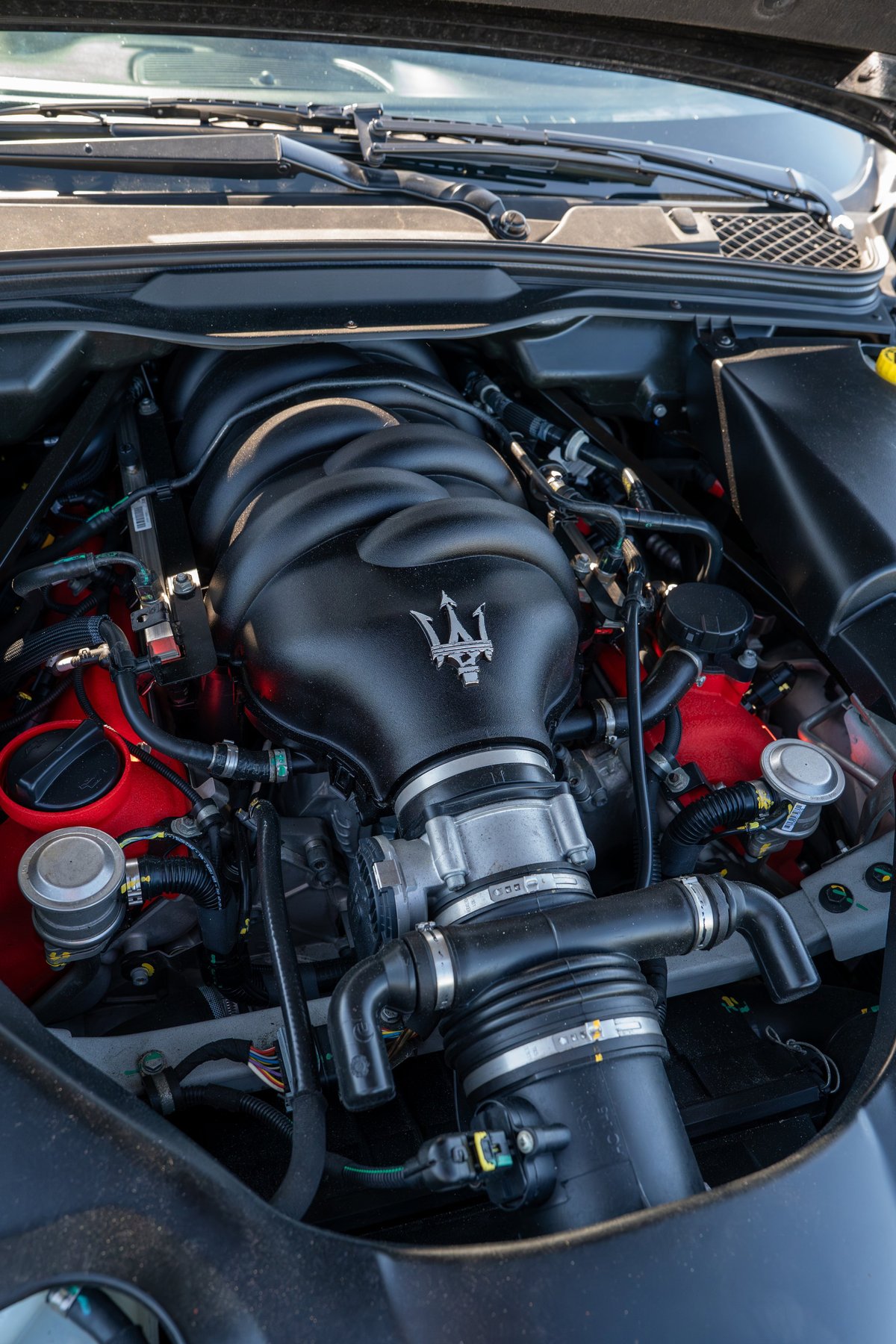 2016 Maserati GranTurismo engine bay with the Trident emblem on the intake manifold.