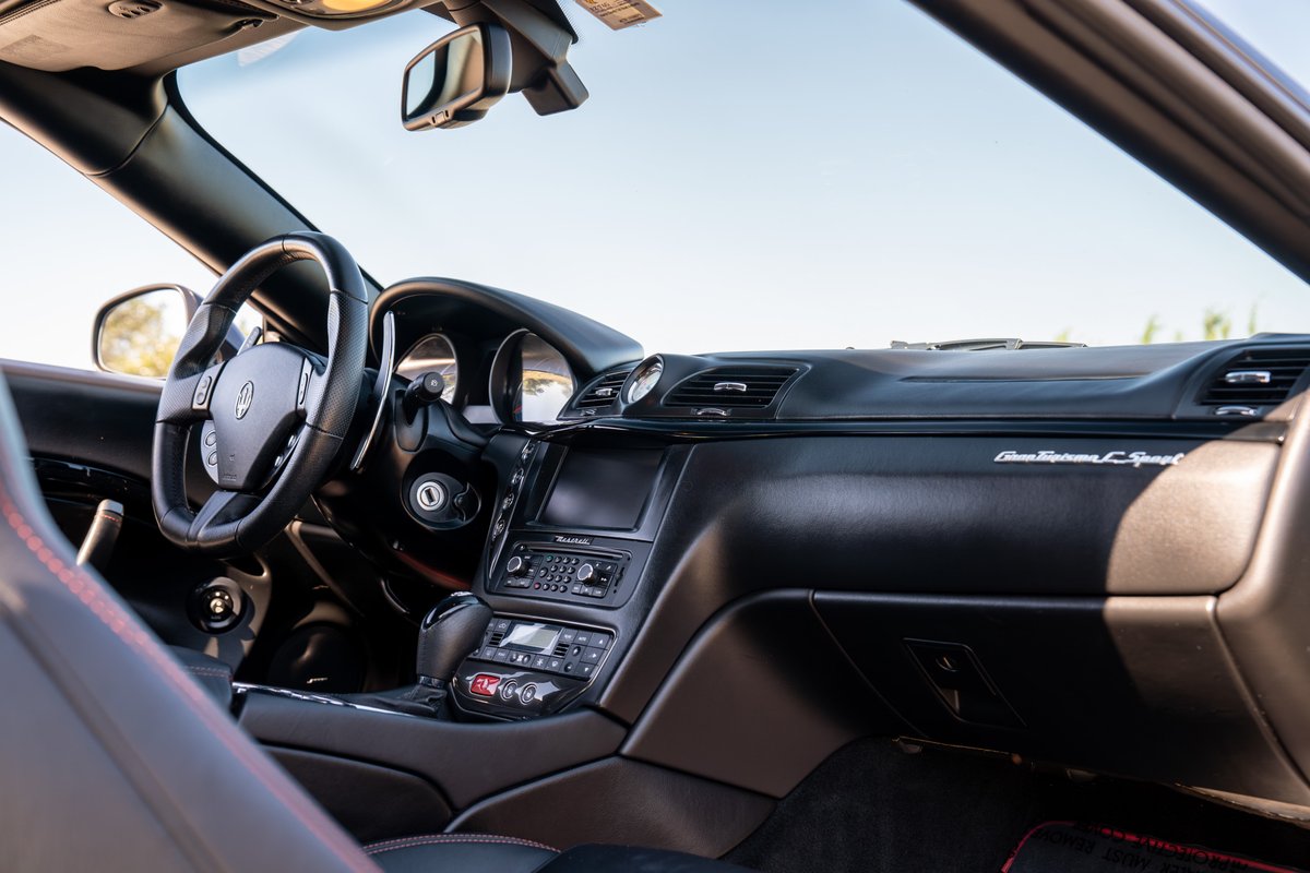 Maserati GranTurismo Sport interior dashboard and steering wheel, black trim.