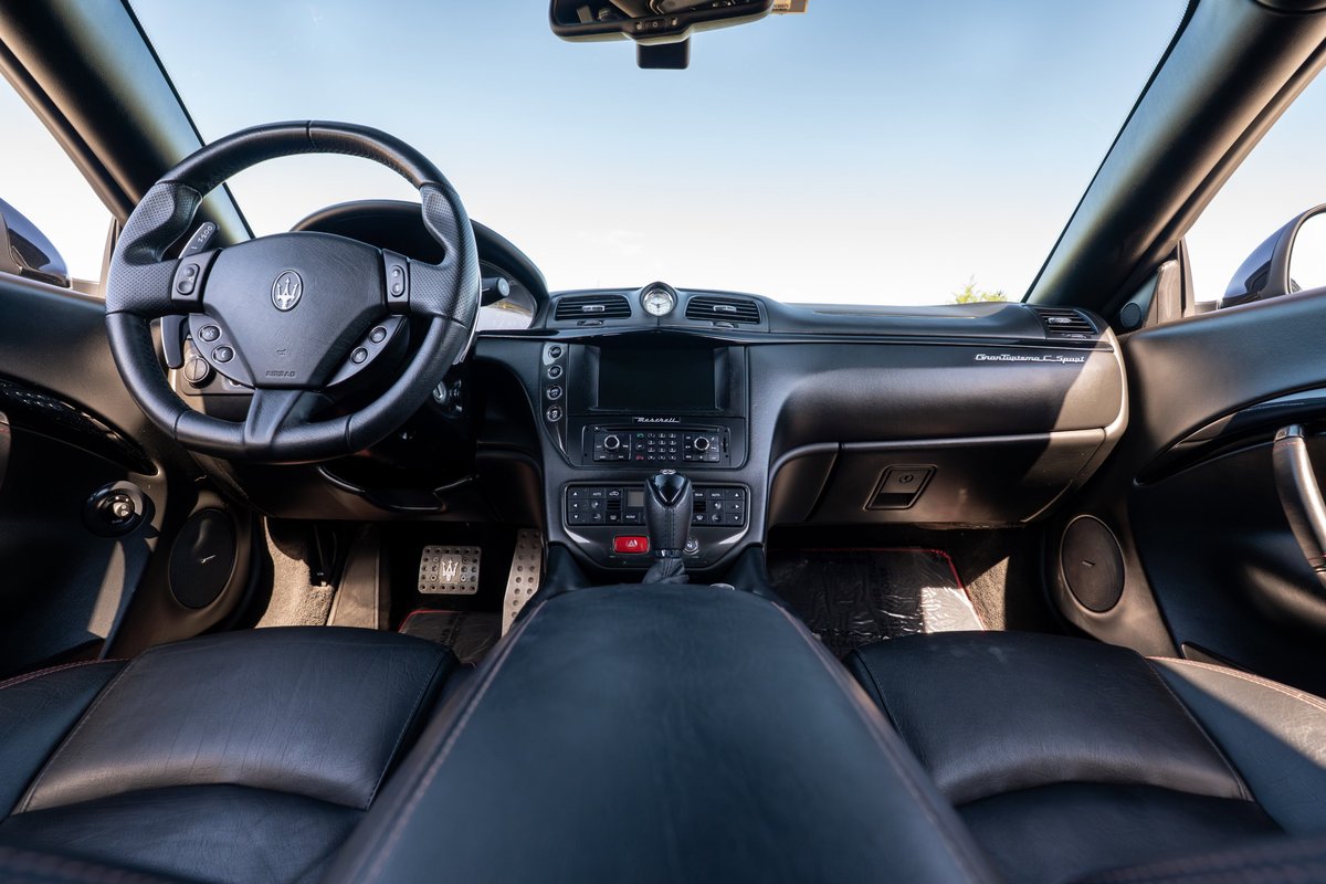 Interior of a black 2016 Maserati GranTurismo S. Black leather seats and steering wheel.