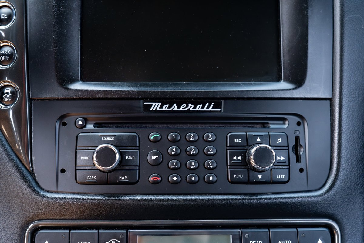 2016 Maserati GranTurismo center console with infotainment screen and radio controls.