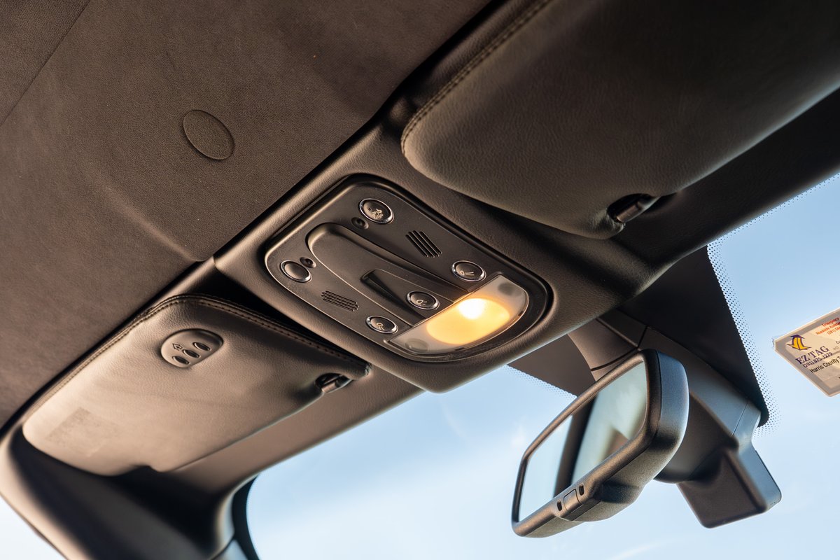 Interior view of a 2016 Maserati GranTurismo with activated dome light and rearview mirror.
