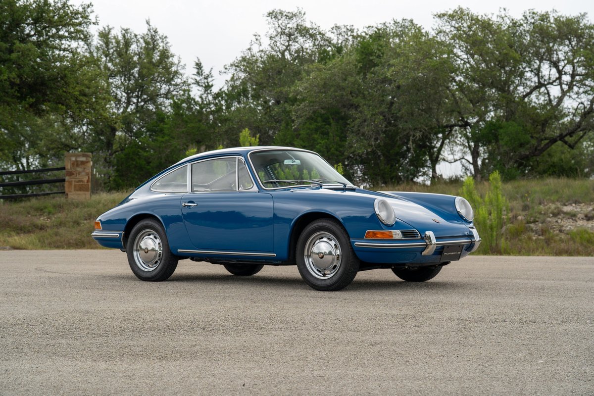 A blue 1965 Porsche 912 Coupe with chrome trim and Fuchs wheels.