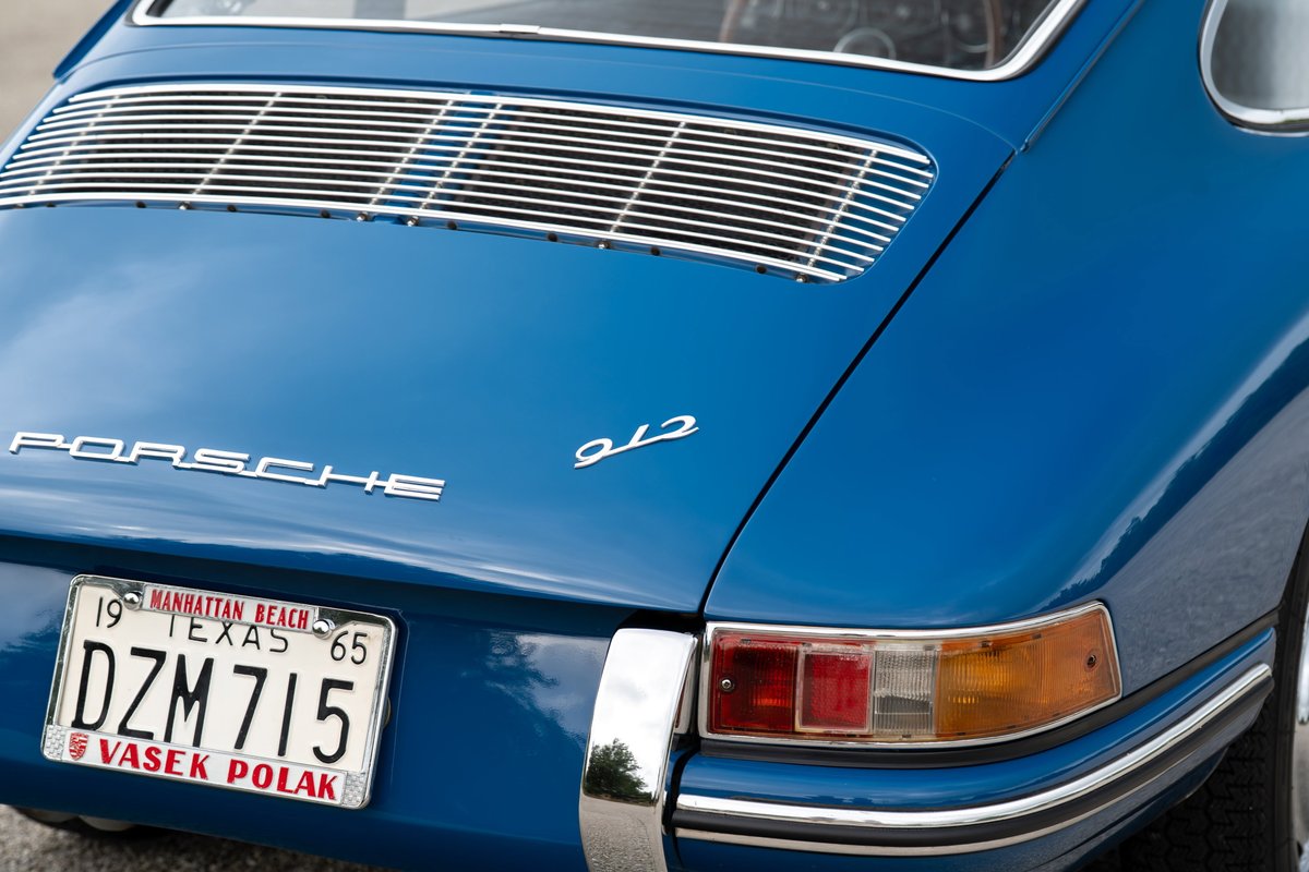 Blue 1965 Porsche 912 with chrome trim and a Texas license plate.