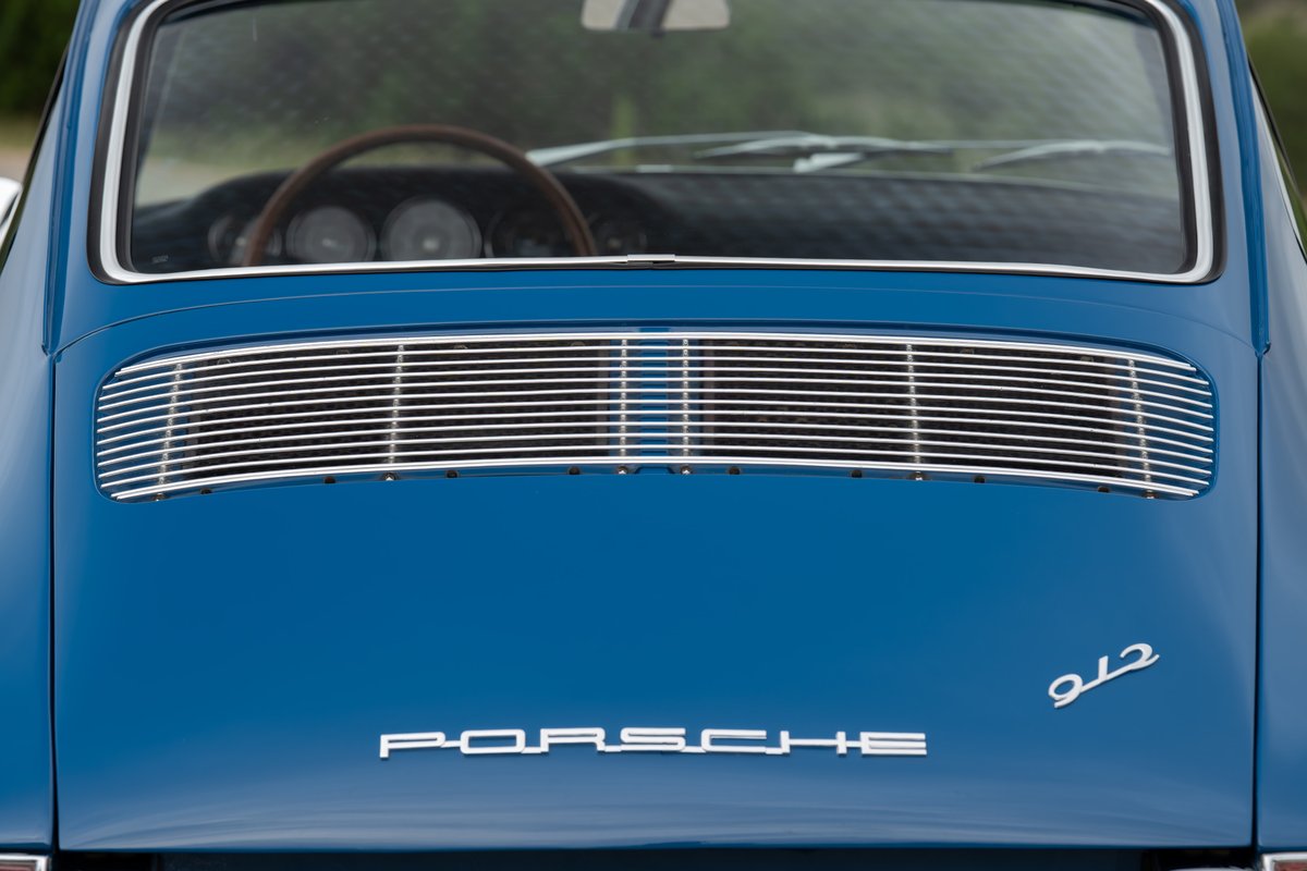 Rear of a blue 1965 Porsche 912 with chrome trim and badging.
