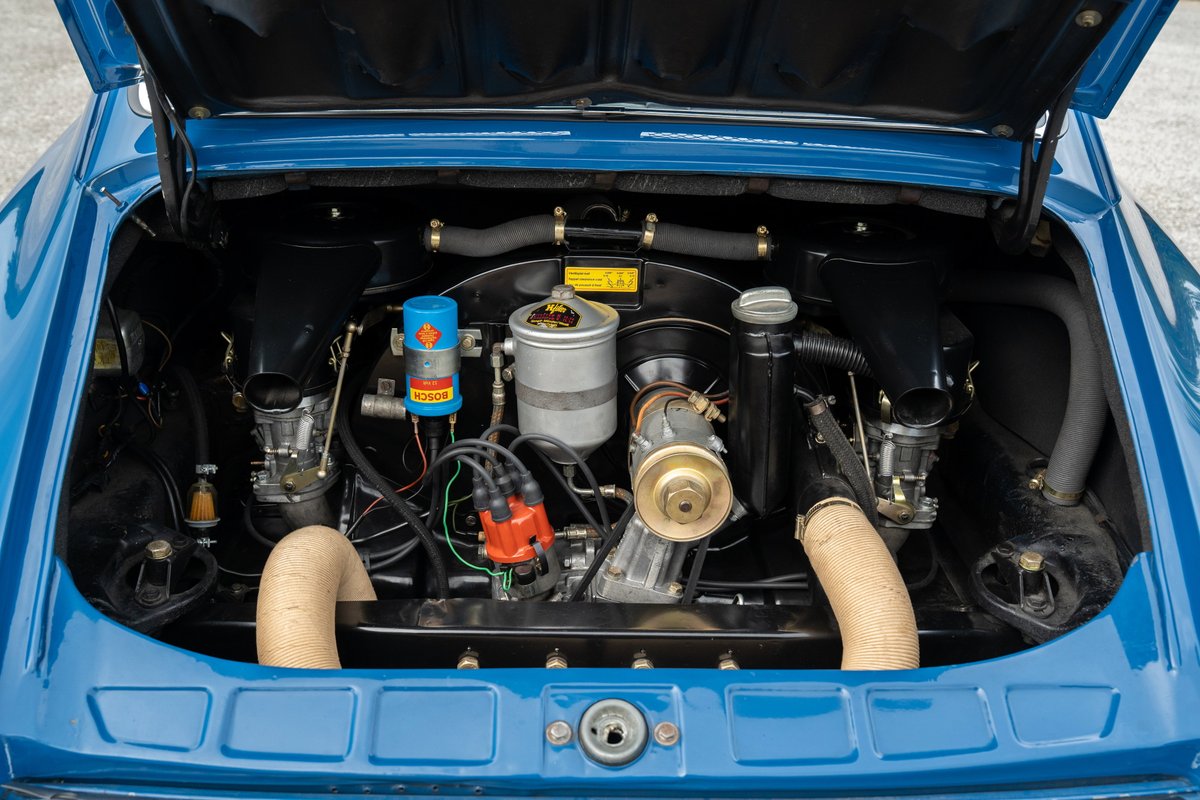 1965 blue Porsche 912 engine bay with dual carburetors and Bosch ignition.