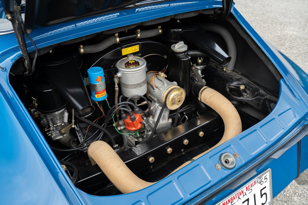 Rear view of a blue 1965 Porsche 912 engine compartment. Features a 4-cylinder boxer engine.
