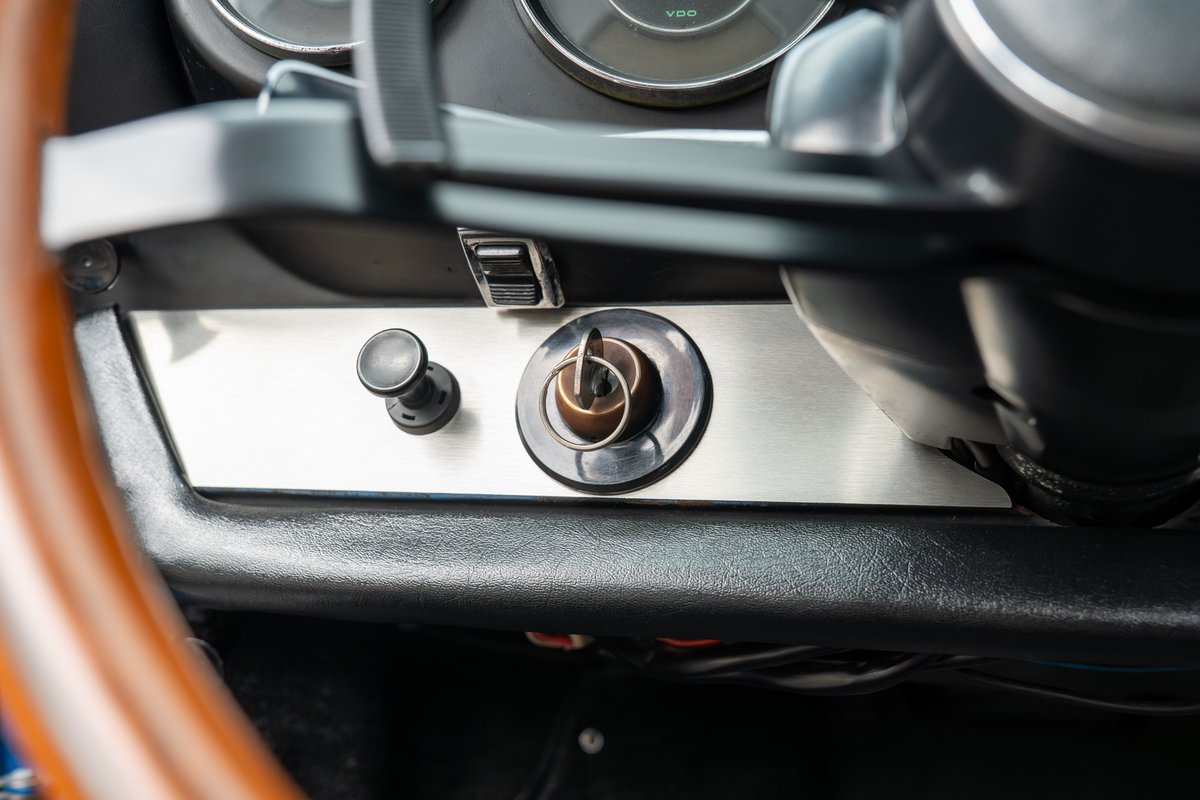 1965 Porsche 912 interior. Brushed metal dash trim with ignition and switch.