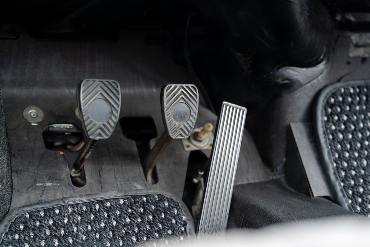1965 Porsche 912 interior: clutch, brake, and gas pedals with textured rubber and aluminum trim.
