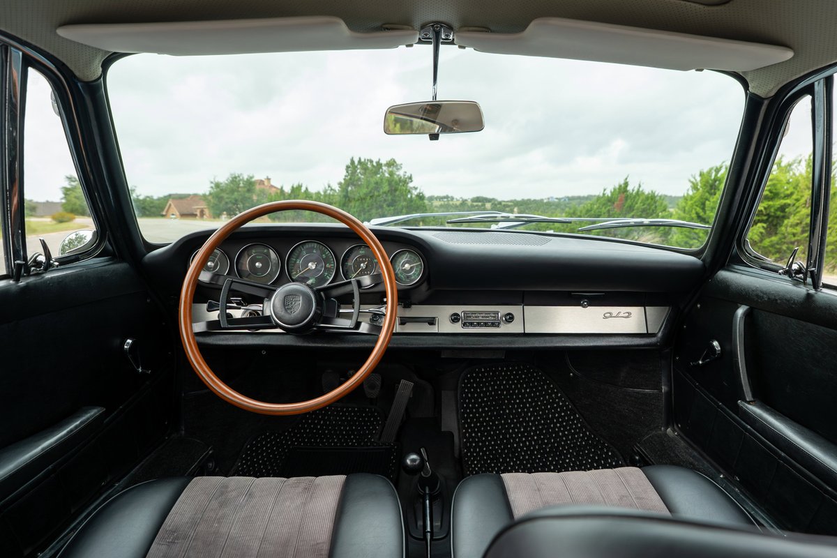 1965 Porsche 912 interior, featuring a wood rim steering wheel and classic gauges.